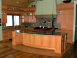large kitchen island and natural wood kitchen cabinets thumbnail
